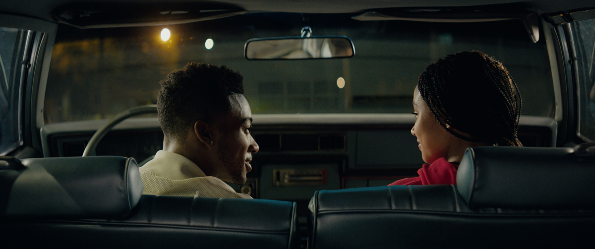 Lamar Johnson and Amandla Stenberg sitting in a car from the film The Hate U Give