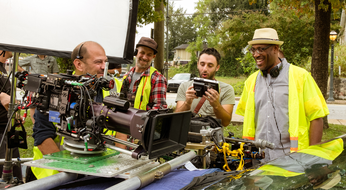The director and crew behind the scenes of The Hate U Give, laughing with some filming equipment