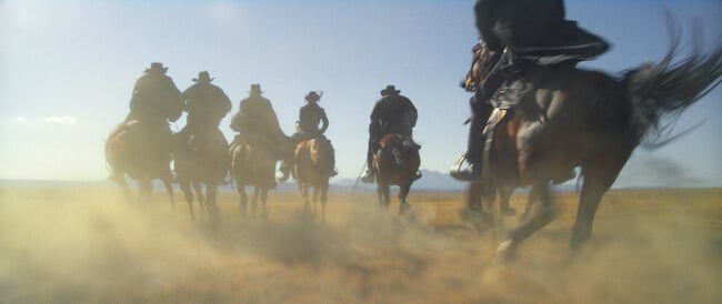 people on horses riding away